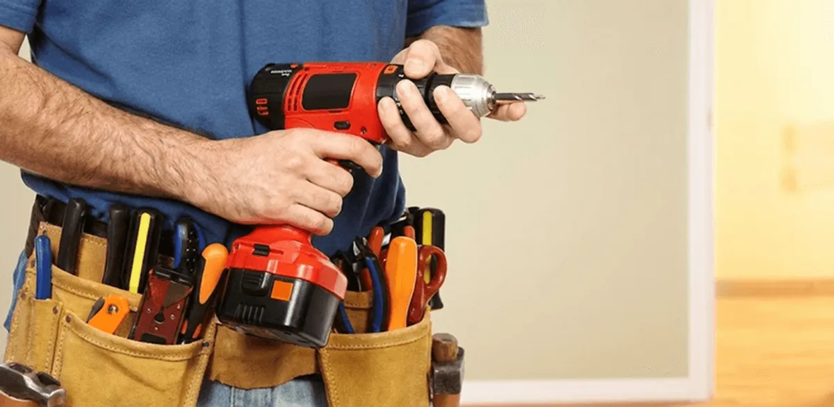 Handyman holding a power drill for home repairs and installations in Lincoln, NE